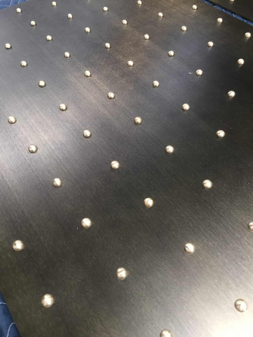 Custom Patinated Bronze Bar Die Wall Panels with Polished Brass Rivet Heads. Matte Lacquer Finish. 